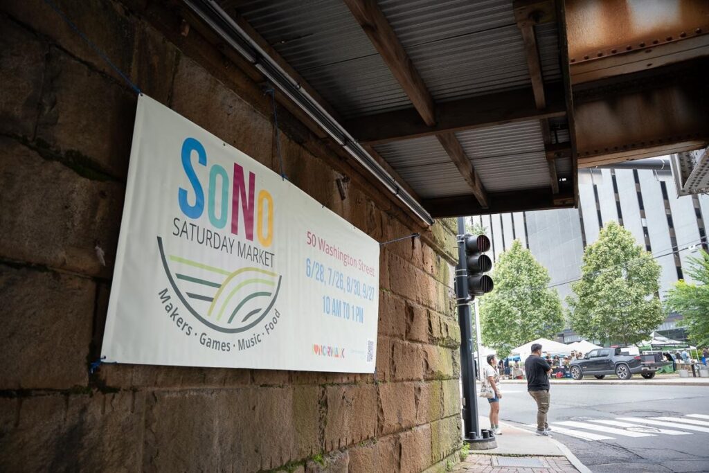 Sign advertising the SoNo Saturday markets in a tunnel of the streets of Norwalk, CT.