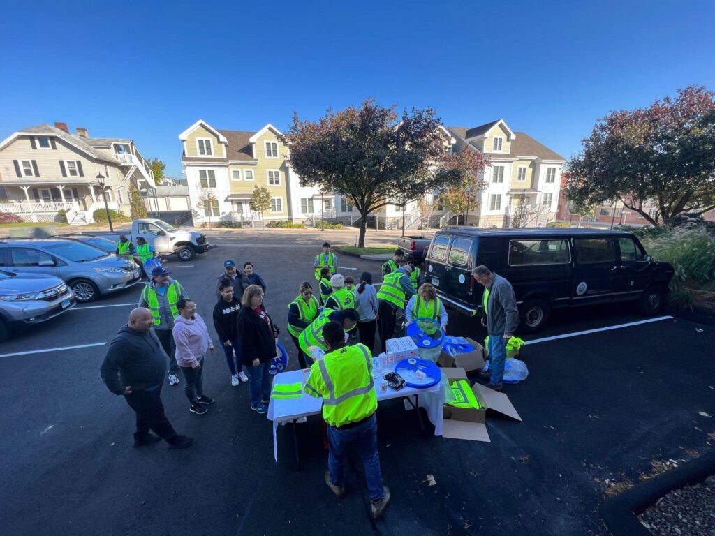 Volunteers gathered at a table in Norwalk, CT, to help with cleaning up littered trash throughout the city.